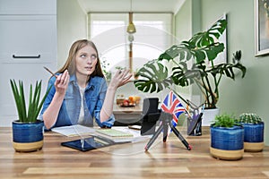 Online English lesson, young woman teaching English to students