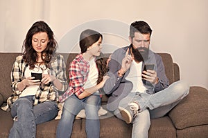 Online family meeting. Little child and parents use cellphones at home. Mobile communication. Cellular communication