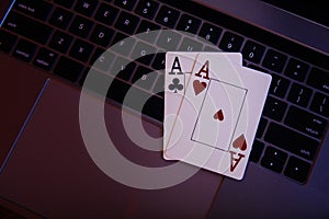 Online gambling theme. Aces on a laptop's keyboard. Top view