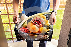 Online grocery shopping service concept - delivery man with food photo