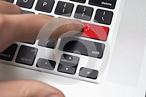 Online International Business concept: Computer key with the China flag on it. Male hand pressing computer key with