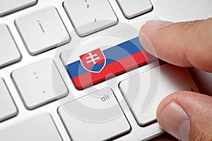 Male hand pressing keyboard key.Slovakia flag button