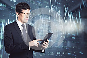 Online investing market concept with trader man touching digital tablet screen on virtual display with stock market quotes