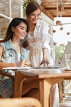 Online Job. Girls With Laptop At Cafe. Business Women In Casual Outfit Working At Coffee Shop. Digital Nomad Lifestyle