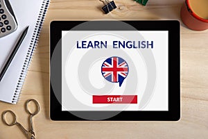 Online learn English concept on tablet screen with office object