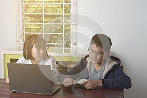 Asian boys and girls sitting studying Using laptop computer