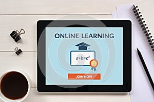 Online learning concept on tablet screen with office objects