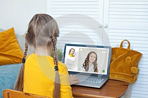 Online learning and education technology concept. Child girl studying online at home