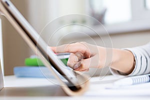 Online learning, remote education background. Kid hand using digital tablet computer