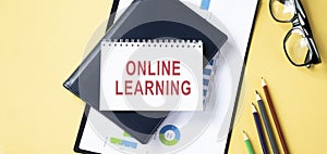 ONLINE LEARNING text inscribed in the notebook photo