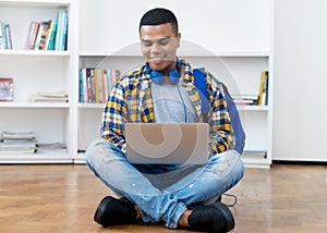 Online lecture and video call at computer of hispanic male student with braces