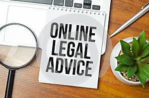 online legal advice words on notebook and laptop on wooden background