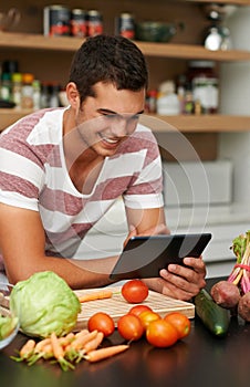 Online, man and cooking with recipe on tablet in kitchen to watch tutorial video with instructions. Learning, guide and