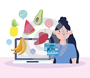 Online market, woman with laptop bank card and fruits vegetalbes food delivery in grocery store photo