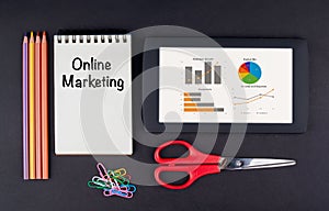 Online Marketing.Tablet, pencils, scissors, paper clips and note