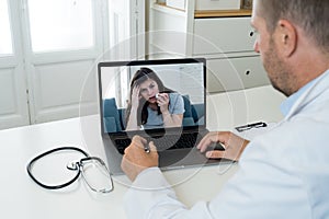 Online medical care. Sick patient on computer screen video calling online doctor in virtual consultation