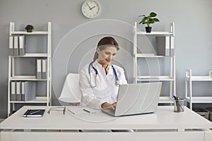 Online medical consultation. Doctor has video chat with a patient using a computer in the office clinic.