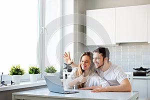 Online meet with relatives or friends. Waving hand in front of laptop monitor.