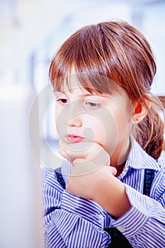 Online meetings and web conferencing. Young beautiful child business girl conferencing with colleague on laptop. Vertical image