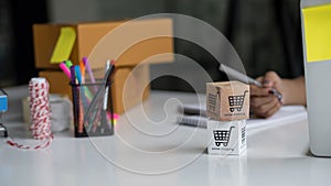 Online merchandise boxes on table, blurred background with boxes a