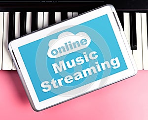 Online Music Streaming poster on tablet keyboard