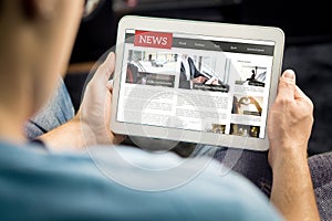 Online news article on tablet screen. Electronic newspaper or magazine. Latest daily press and media. Mockup of digital portal. photo