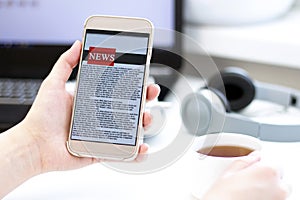 Online news on a mobile phone. Close up of businesswoman reading news or articles in a smartphone screen application.