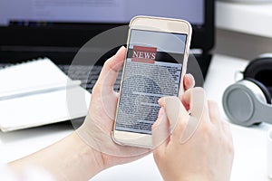 Online news on a mobile phone. Close up of businesswoman reading news or articles in a smartphone screen application.