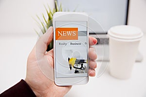 Online news in mobile phone. Close up of smartphone screen. Man reading articles in application. Hand holding smart