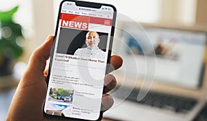 Online news on a smart phone. Close up of businessman reading news or articles in a mobile phone screen app. Hand holding smart
