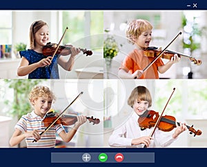 Online orchestra rehearsal. Kids play violin