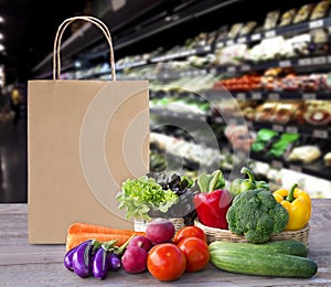 Online order grocery shopping concept. Food delivery ingredients service at home for cooking with packages bag on wood table on