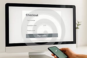 Online payment checkout process on computer screen and smartphone