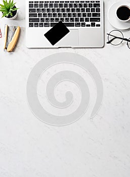 Online payment concept, mock up credit card with office desk computer isolated on beautiful marble background, workspace design,