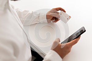 Online payment, credit card and Businessman hands using smartphone and holding credit card