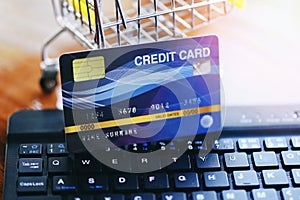 Online payment credit card on keyboard and shopping cart background / shopping online technology and credit card payment