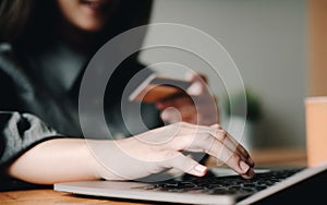 Online payment, digital banking. woman hand using credit card for online shopping via laptop computer on table