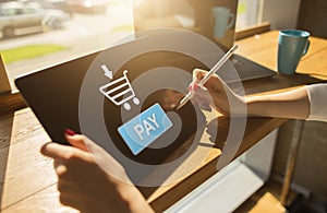 Online payment an e-commerce concept. Pay button on tablet screen.
