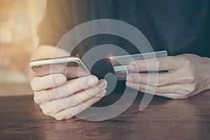 Online payment,Man`s hands holding smartphone  and using credit