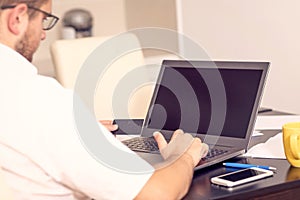 Online payment, Manâ€™s hands holding a credit card and using laptop computer for online paying bills