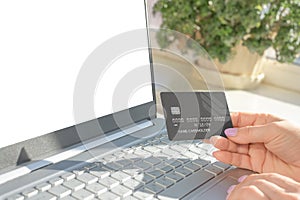 Online payment for purchases by credit card. Hands holding credit card and using mockup laptop. online shopping and payment makes