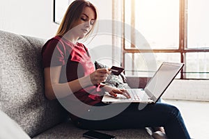 Online payment, woman holding credit card and laptop for online shopping.