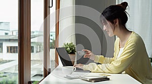 Online payment, Woman& x27;s hands holding credit card and using laptop computer for online shopping.