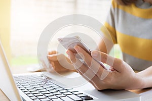 Online payment, Woman's hands holding a credit card and using sm