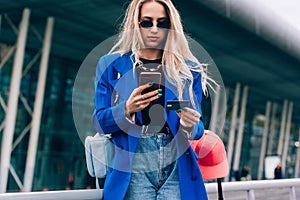 Online payment. Woman& x27;s hands holding a credit card and using smart phone for online shopping.