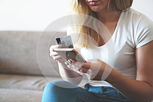 Online payment, Womans hands holding smartphone and using credit card