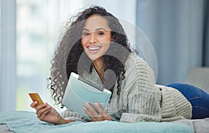 Online payments are so simple now. a young woman using her digital tablet to make online card payments.