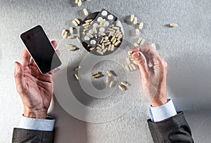 Online pharmacy concept - businessman hands holding phone to order drugs
