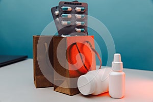 Online pharmacy. Paper bags with prescription drugs and pills and white conteiners