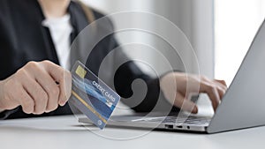 Online product purchase, Businesswoman use laptop register via credit cards to make online purchases